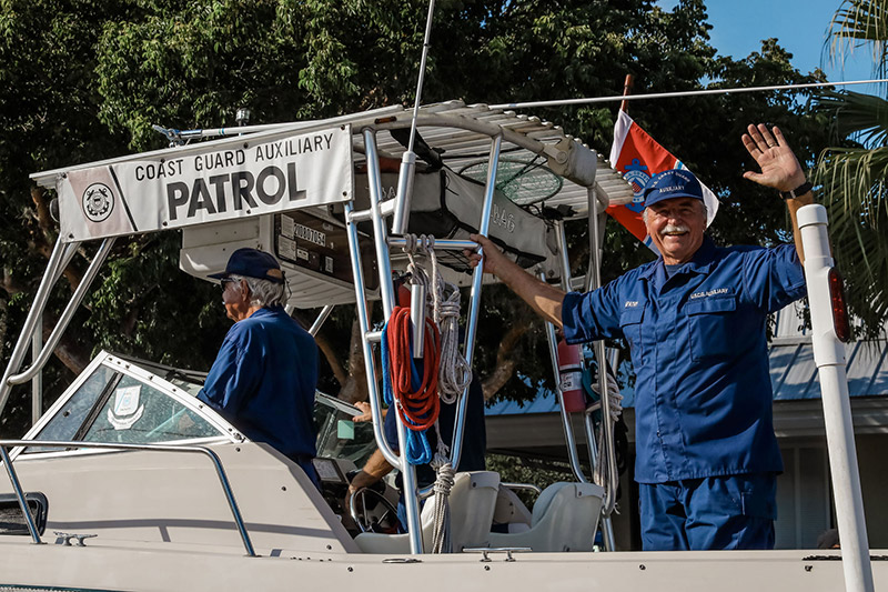 two men on a boat with a Patrol banner